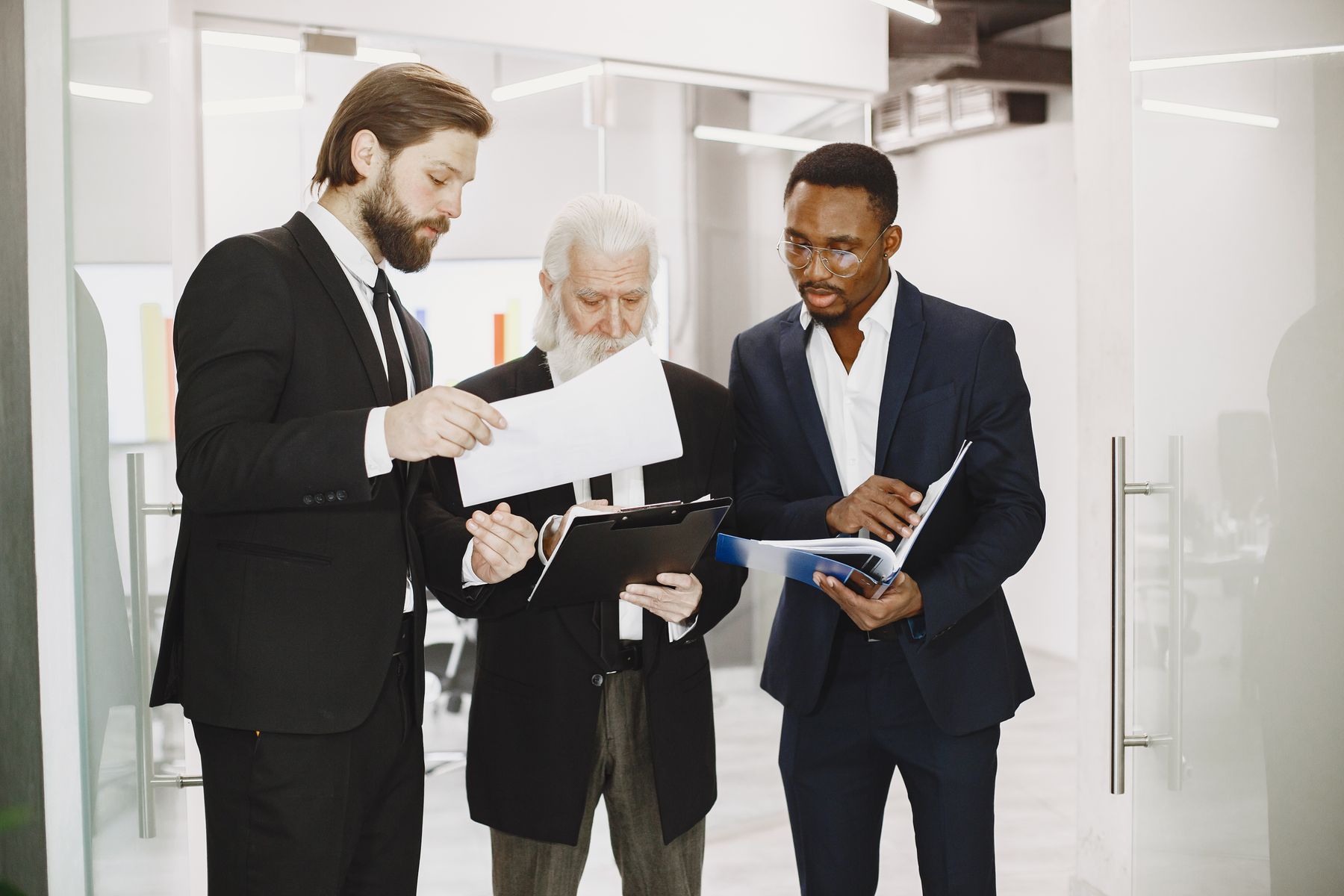 Senior business team coordinating documents and decisions