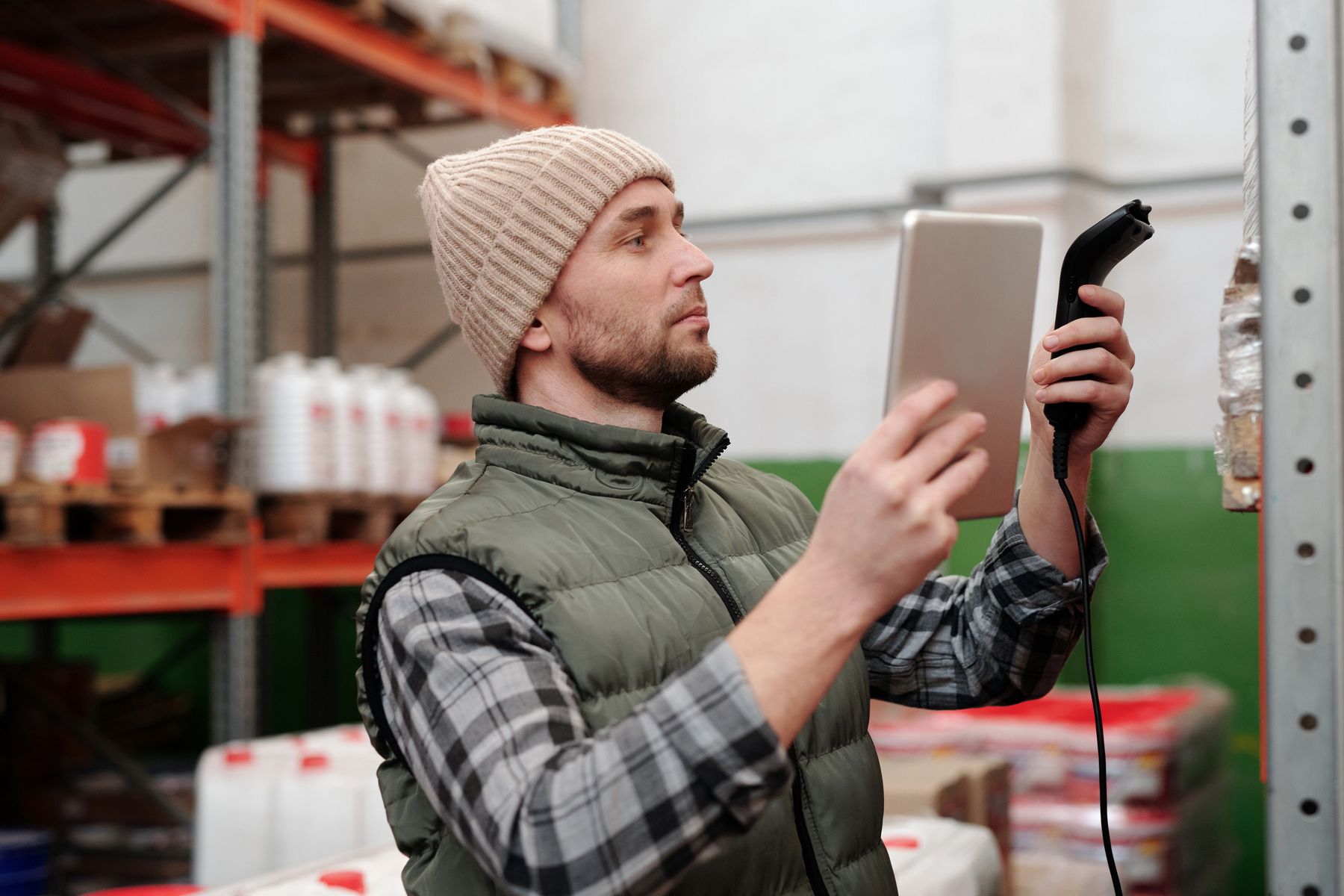 Logistics specialist scanning inventory in a controlled warehouse